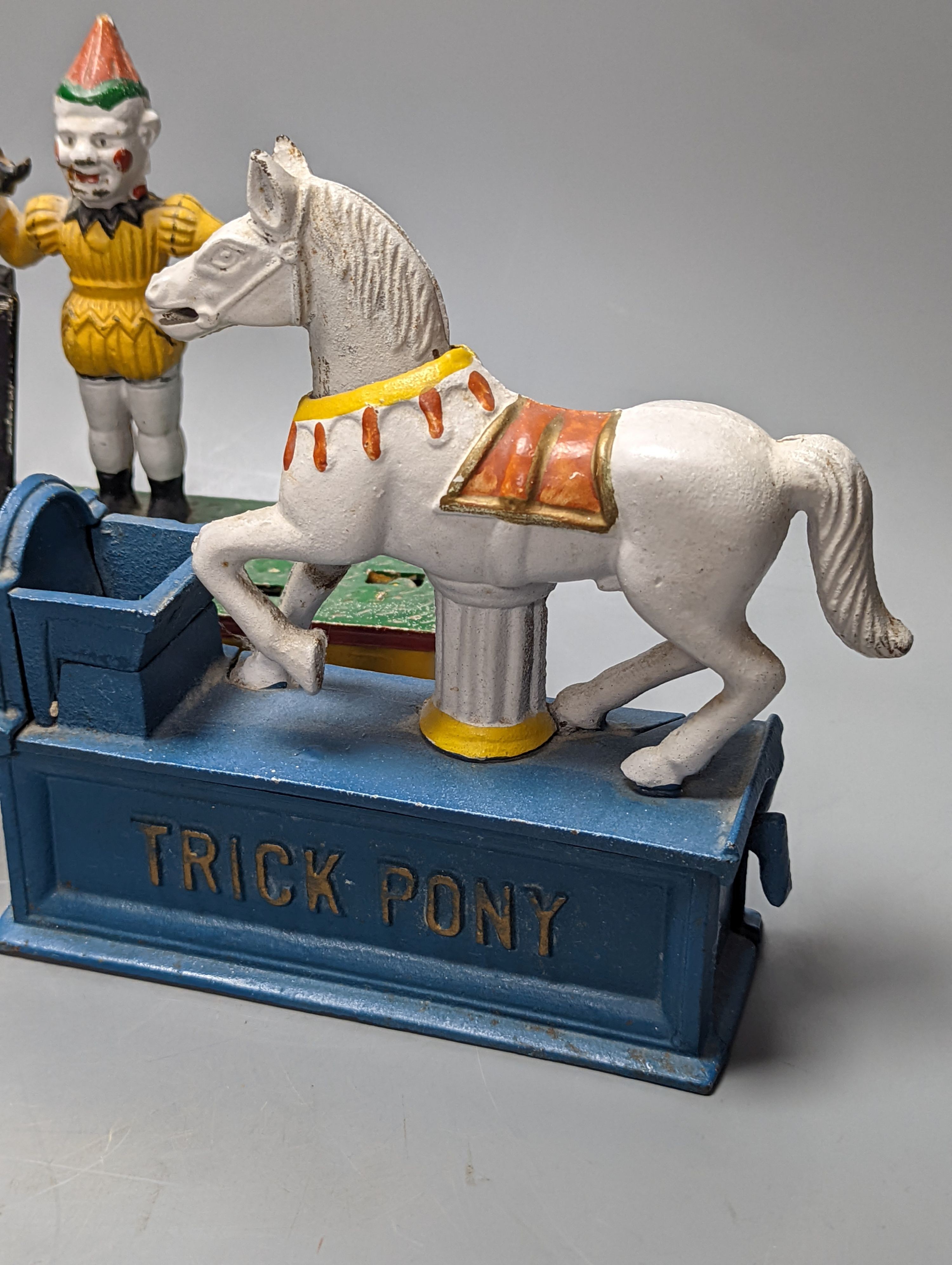 Two painted cast iron money banks ‘Trick Dog’ and ‘Trick Pony’, and a serpentine bathtub